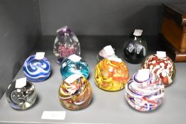 An assorted collection of art glass paperweights, by Langham, CIIC, and others