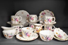 A Royal Crown Derby bone china tea set, hand decorated with flowers, and including six tea cups