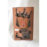 A mid century terracotta tile having abstract depiction of a king.
