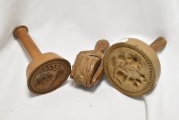 Two 19th century wooden biscuit moulds and a pasty wheel.