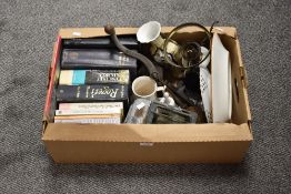 An assortment of items including a selection of books, a very vintage long nosed oil can and a large