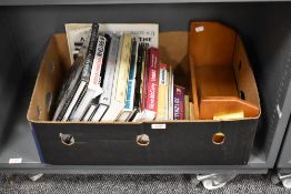 A small wooden table bookshelf and a selection of books of mainly photography interest including