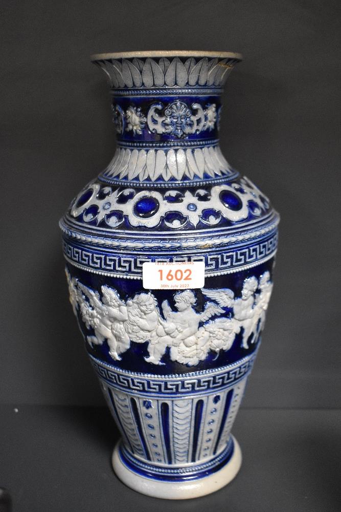 A 19th century Rhenish pottery vase, having relief Cherub, motifs and Greek key decoration, AF