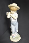 A Lladro boy figurine Flowers On The Back no.1286. Designed in 1974 retired in 1998. 9 inches x 3.