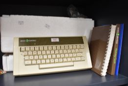 A vintage Acorn Electron computer including user guide and introductory cassette.