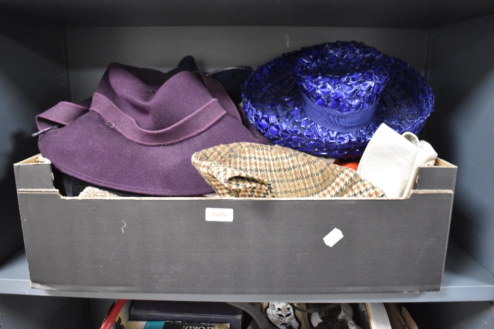 A box of ladies and gentleman's outdoor hats and other garments