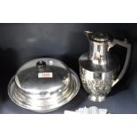 A silver plated coffee pot and a serving dish.