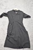 A late 1940s/ early 1950s black medium weight cotton day dress, having button accent to sleeve and