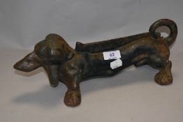 A heavy cast iron boot scraper in the form of a Dachshund