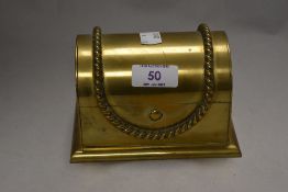 A novelty brass jewellery box in the form of a dome topped treasure chest, having a purple velvet