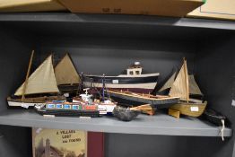 An assorted group of painted wooden boat models, of different sizes, the largest measuring 36cm
