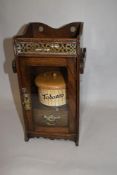 A late 19th Century oak cased gentleman's pipe cabinet, the galleried upper level above a glazed