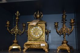A late 19th Century French brass clock and garniture set, the clock with a two train movement,
