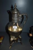 A vintage glass and plated metal tea/ coffee carafe, having receptacle to underside to hold a candle
