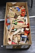 A box full of wooden toy trains and track.