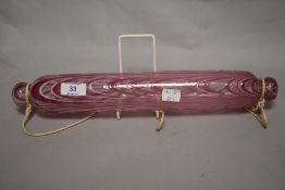 A Victorian glass Nailsea style rolling pin, decorated with bands of pink and white, 40cm long