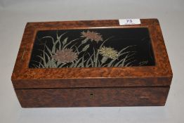 A late 19th/early 20th Century walnut games box, with floral lacquered top, and containing Chas