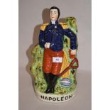 A reproduction Staffordshire pottery flatback Napoleon ornament, measuring 32cm tall