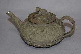 A Josiah Wedgwood teapot of squat form, having a relief moulded patterned body, and measuring 9cm