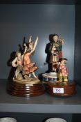 Three vintage musical figurines, including Reuge Swiss made clown with horn.