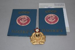 A Soviet Union Navy Officer hat badge and two Soviet passport covers