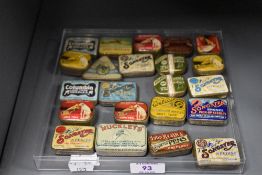 An assortment of vintage gramophone needle tins and similar advertising tins.