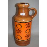 A mid-20th Century West German vase, by Scheurich, with a loop handle and a decorative orange