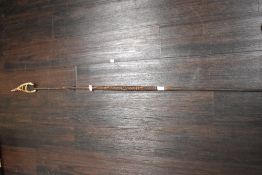 A South African style spear, having carved wooden handle and beaded sheath.