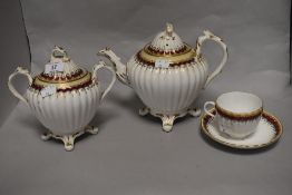 A Victorian porcelain three piece part tea service, to comprise a twin handled lidded pot, a teapot,