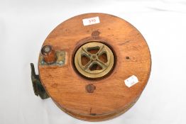 A Large wood and brass fishing reel 23cm diameter