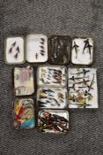 An assortment of vintage tackle including spinners and lures in tobacco tins
