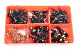 A pocket box containing approximately 70 fishing flies. Special Montanas