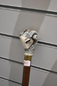 A walking cane with a cast resin rams head handle measuring 92cm