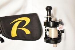 A reel from The Rocket Reel Company model TG-F2 in original soft pouch