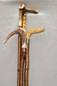 Four Antler topped walking sticks of varying lengths from 123cm-143cm