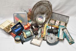 A crate of vintage fishing tackle including 4 reels and several tins of old lures and flies one