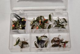 A pocket box containing approximately 60 fishing flies. Corixa fresh water shrimp