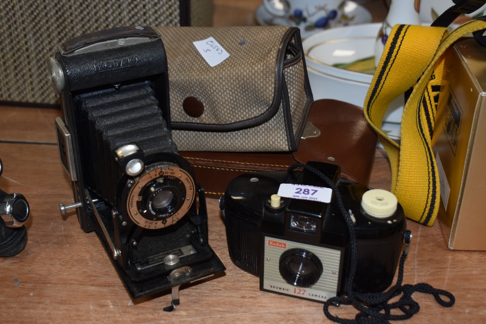 A Kodak Six-20 folding camera and Kodak Brownie 127 camera