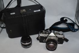 An Olympus OM-2 camera with a F.Zuiko Auto S 1:1,8 f=50mm lens and an Ensinor MC Auto 1:2,8 f=28mm