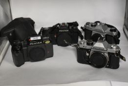 Four Asahi Pentax camera bodies. A Pentax A3 No3361411, a Pentax K1000 No6729236, a Pentax K2