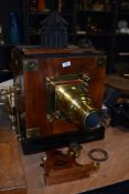 A Newton & Co, Fleet St, London mahogany and brass magic lantern/ projector with two boxes of