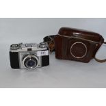 A Zeiss Ikon camera with 1:3,5 f45mm lens in leather cover and Yashica light meter