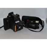 Two cameras. A Polaroid Colour Swinger instant camera and a Hanimex 35AFX camera