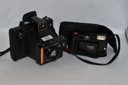 Two cameras. A Polaroid Colour Swinger instant camera and a Hanimex 35AFX camera