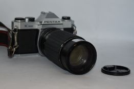 A Pentax K1000 camera No5385153 with Sigma High speed zoom 1:3,5-5,4 f80-200mm lens No505623 in soft