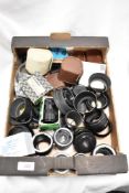 A box of various lens converters, tubes and filters