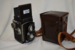 A Microcord reflex camera in leather case