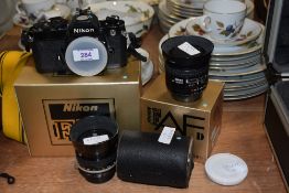 A boxed Nikon FM camera body FM2517865 with Nikon Nikkor AF 1:2,8 D 28mm lens No409344, a Nikon