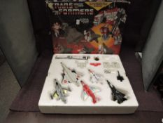 A 1985 Hasbro Takara Transformers Aerialbot Air Warrior Superion Set, comprising five smaller