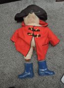 A 1970's Gabrielle Designs Paddington Bear wearing black hat, red jacket and blue wellingtons,